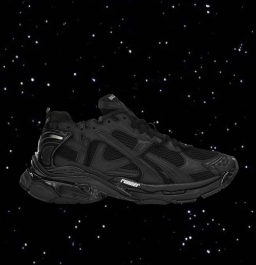 Black Balenciaga Runners with a mesh upper and chunky sole set against a black starry background.